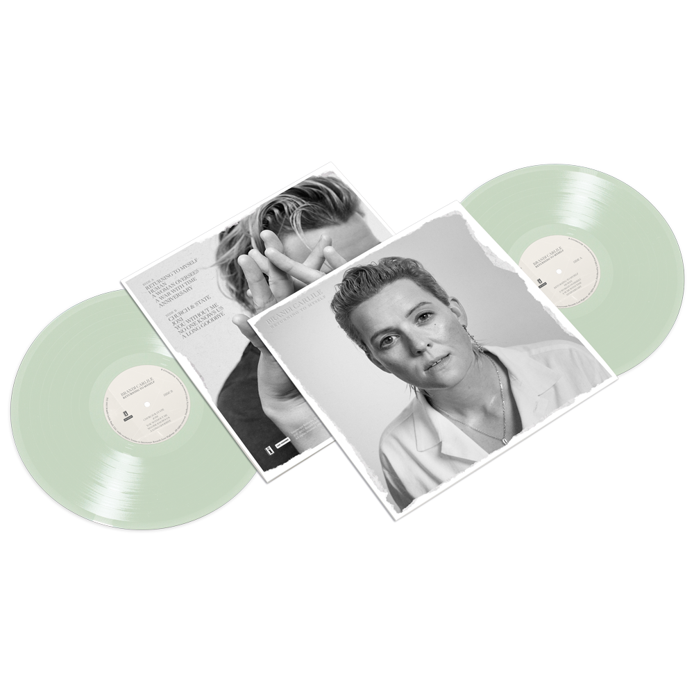 Two green vinyl records with black and white vinyl album sleeves. 